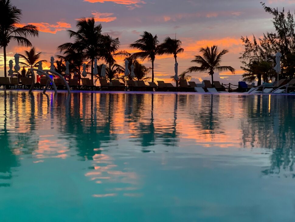 beautiful sunset view in Turks and Caicos with palm trees and water