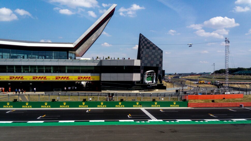The pitlane entrance, starting grid and podium at Silverstone motor racing circuit during the 2018 Formula 1 British Grand Prix.