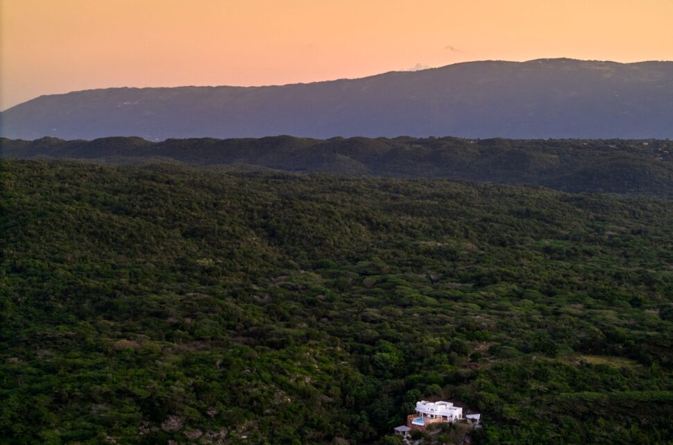 aerial drone shot of Amelia's standing alone with views of lush green hills